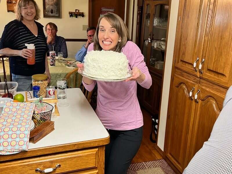 Showing off a homemade cake in the kitchen