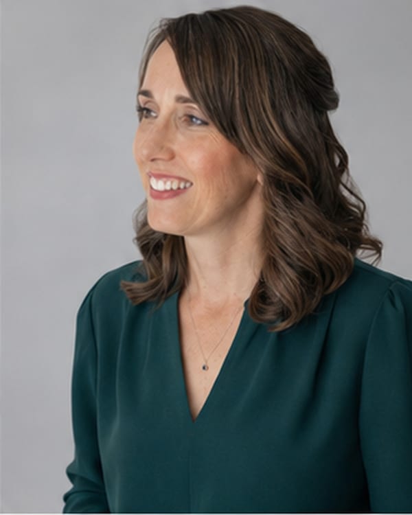 Teresa Huff studio portrait, green blouse, gray backdrop