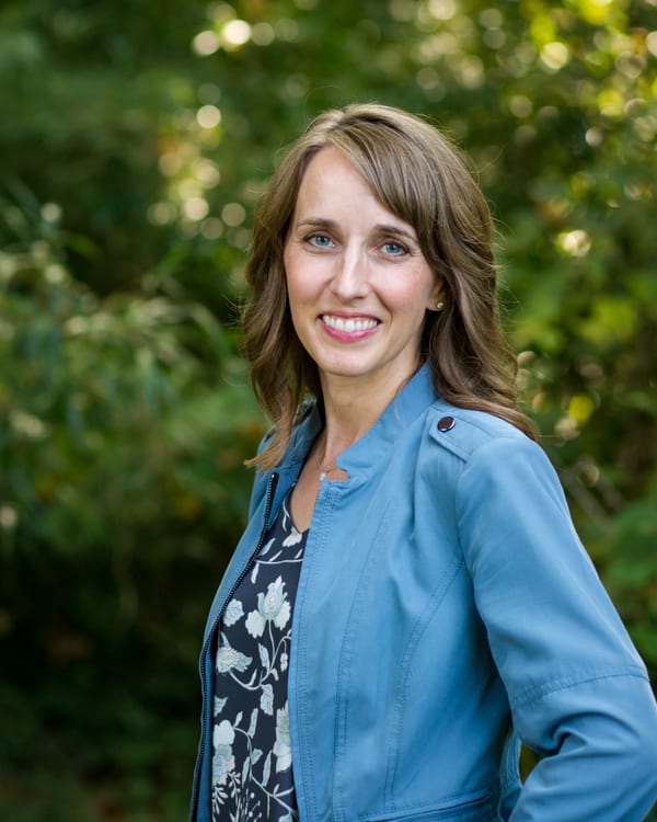Teresa Huff headshot, denim jacket, outdoors